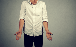 A man shrugs in frustration wondering if his saggy balls mean varicocele