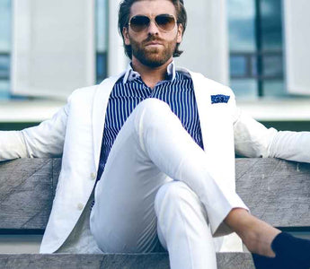 A man wears a white suit