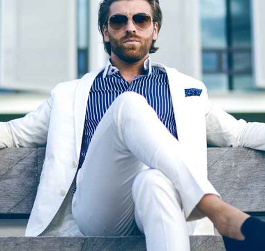 A man wears a white suit