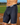 A man wears black regular support UFM underwear while playing baseball to prevent chafing