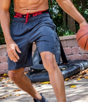 A man wears UFM underwear beneath gym shorts while playing basketball