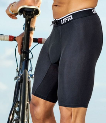 A man wears long UFM boxer briefs while cycling for support and comfort