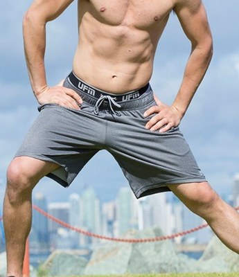 A man wears gray UFM underwear underneath gym shorts for chafing support while on a run