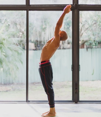 A man does yoga wearing UFM underwear beneath his joggers for isolation and comfort during his flow.