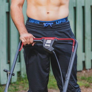 Man wearing men's pouch underwear while mowing lawn, designed to keep you cool and dry in high heat.