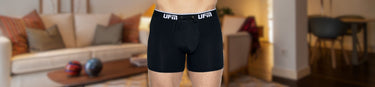 A man wears black UFM pouch underwear designed for scrotal support and comfort