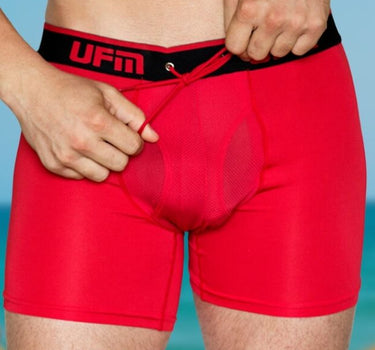 A man ties UFM adjustable support pouch underwear to create a hammock for his balls.